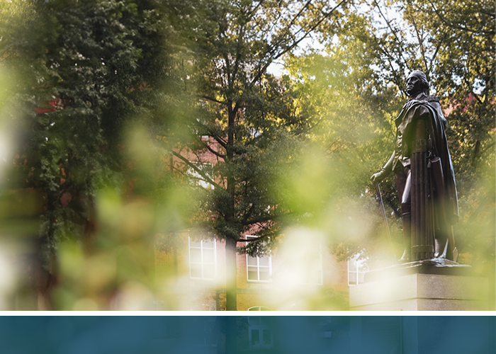 George statue in spring surrounded by green