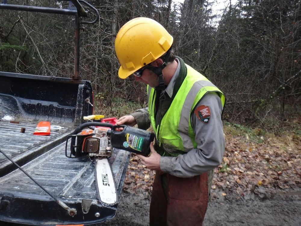 Aric Baldwin, maintenance worker – supervisor (trails), putting biobased oil to use in the backcountry. Photo courtesy of Klondike Gold Rush National Park.