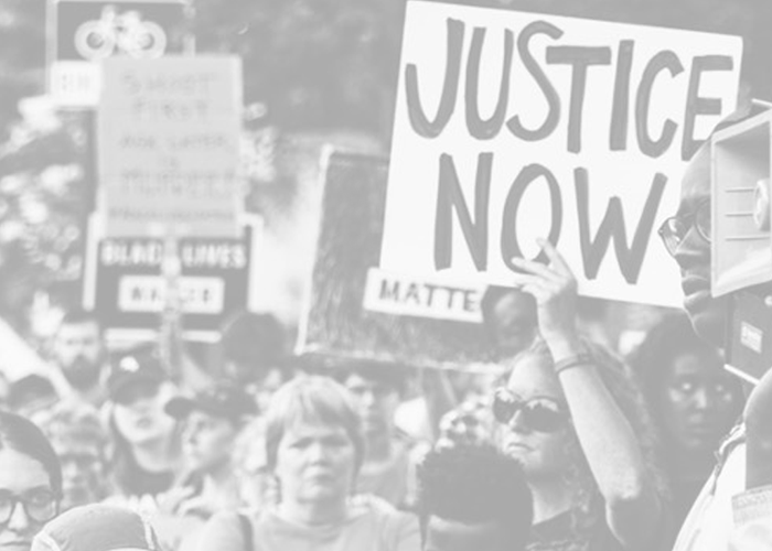 protesters holding justice now signs